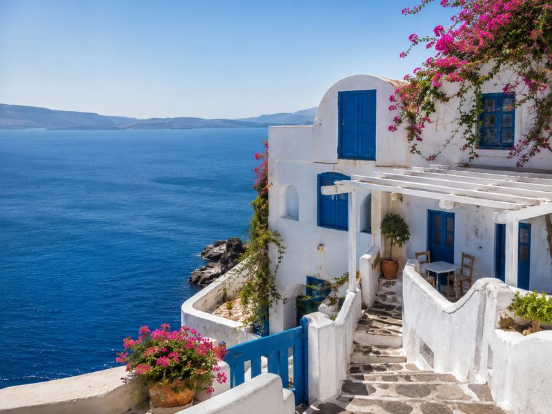 Greek island coastal village — whitewashed buildings and blue sea